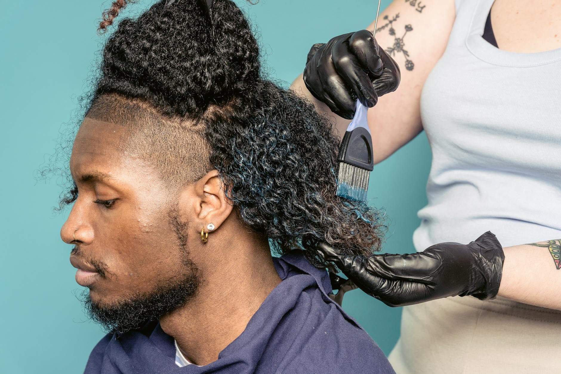 Coiffeuse appliquant une coloration sur cheveux dans un salon lumineux